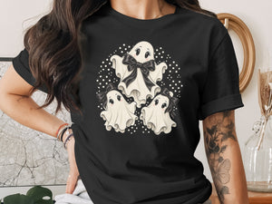Black t-shirt with three cartoon ghosts and black bows, surrounded by polka dots.