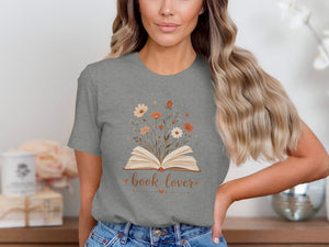 Grey t-shirt with an open book design surrounded by flowers and the text "book lover".