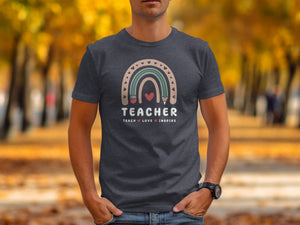 Teacher shirt with rainbow, pencil, and hearts graphic, reading "TEACHER TEACH LOVE INSPIRE".
