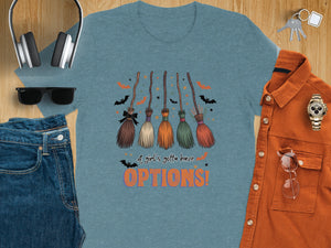 Blue t-shirt with five broomsticks, bats, stars, and text "A girl's gotta have OPTIONS!".