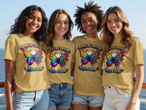 Four friends in tan t-shirts with "BROKEN CRAYONS STILL COLOR" and butterfly graphics smile.