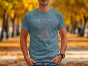 Teal t-shirt with pink text "You Belong Among the Wildflowers" and floral graphic.