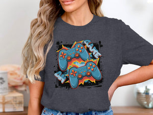 Two blue video game controllers with orange accents on a dark t-shirt.