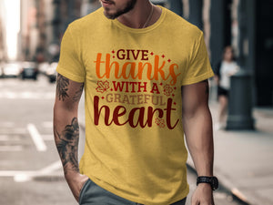 Yellow t-shirt with "Give thanks with a grateful heart" text and autumn leaves.