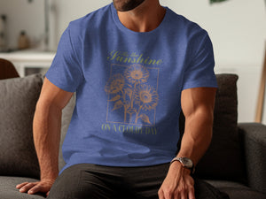 Blue t-shirt with sunflowers and text "Be the Sunshine ON A CLOUDY DAY".