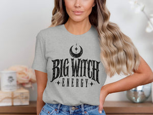 Grey t-shirt with "BIG WITCH ENERGY" text and a crescent moon design.