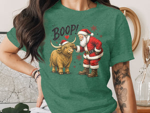 Santa booping a fluffy Highland cow, with "BOOP!" text and snowflakes.