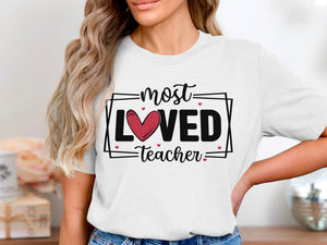 White t-shirt with "most LOVED Teacher" and red heart graphic.
