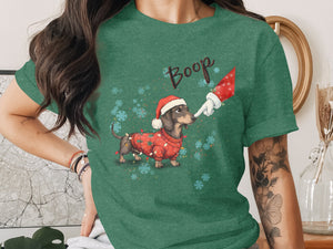 Dachshund wearing a Christmas sweater booped by Santa's finger.