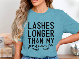 Teal t-shirt with black text "LASHES LONGER THAN MY patience" and eyelash graphics.
