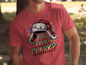 Red t-shirt with a festive graphic of a plaid hat wrapped in Christmas lights and the text "YOU SERIOUS CLARK?".
