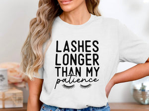 White t-shirt with black text: "LASHES LONGER THAN MY patience" and eyelashes.