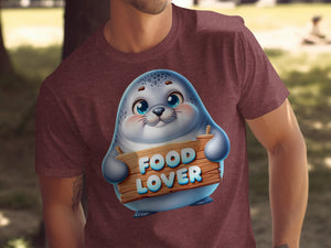 Cute seal character on maroon t-shirt holding wooden sign that says "FOOD LOVER".