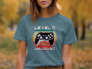 T-shirt graphic with a video game controller and text "LEVEL 11 UNLOCKED".