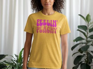Gold t-shirt with pink and orange "Feelin' Peachy" text and stars.