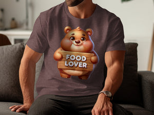 Brown t-shirt graphic of a round bear holding a wooden sign that says "FOOD LOVER".