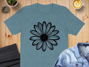 Teal t-shirt with black daisy graphic, styled with denim jacket and coffee.