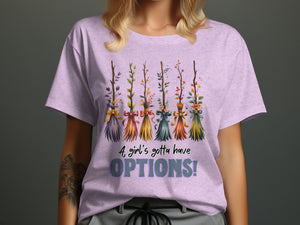T-shirt with five decorated brooms and the text "A girl's gotta have OPTIONS!".
