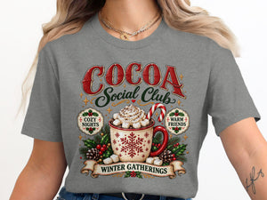 Cocoa Social Club graphic with hot cocoa, marshmallows, candy cane, and text.
