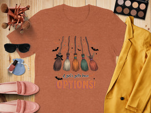 Orange t-shirt with Halloween graphic of witch brooms and text "OPTIONS!".