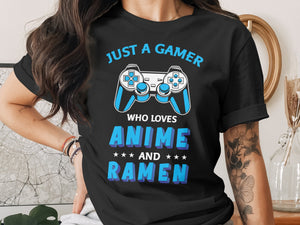Black t-shirt with "JUST A GAMER WHO LOVES ANIME AND RAMEN" text and controller graphics.