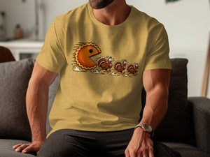 Pie character chasing cartoon turkeys on a yellow t-shirt.