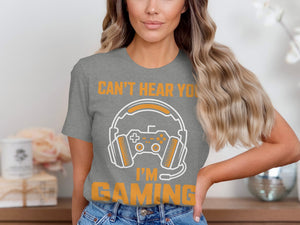 Grey t-shirt with orange text "CAN'T HEAR YOU I'M GAMING" and gaming graphics.