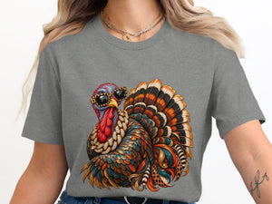 Colorful jeweled turkey with sunglasses and leopard print accents on a gray t-shirt.