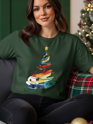 Green t-shirt with abstract rainbow Christmas tree graphic and a yellow star.
