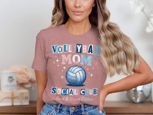A woman wearing a mauve t-shirt with the graphic text Volleyball Mom Social Club and a volleyball illustration.