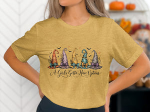 Witch hats graphic with text "A Girls Gotta Have Options" on a yellow t-shirt.