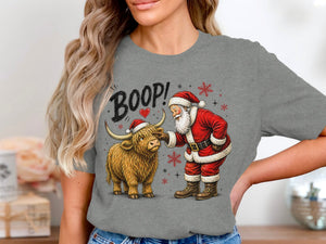 Santa boops a Highland cow wearing a Santa hat, with "BOOP!" text.