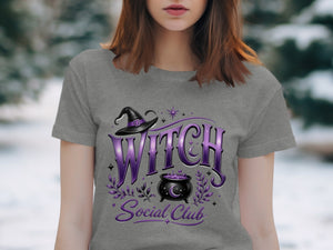 Grey t-shirt with "Witch Social Club" text, hat, and cauldron design.