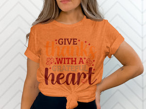 Orange t-shirt with "GIVE thanks WITH A GRATEFUL heart" text and fall leaves.