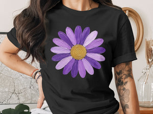 Black t-shirt with a painted purple daisy and gold center graphic.