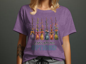 Purple t-shirt with five decorative brooms and text "A girl's gotta have OPTIONS!".