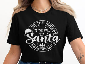 Black t-shirt with white graphic: "To the wall til Santa decks these halls"