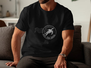 Black t-shirt with circular stamp graphic of sea turtle and text "Coastal Post Service Sea You Soon."