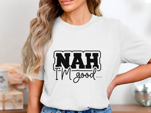 White t-shirt with "NAH I'M good..." text graphic.