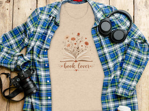 Peach t-shirt with open book and flowers graphic that reads "book lover."