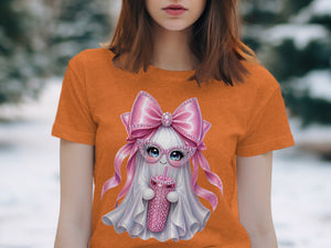 Orange t-shirt with a sparkly ghost wearing a pink bow and sunglasses holding a pink drink.