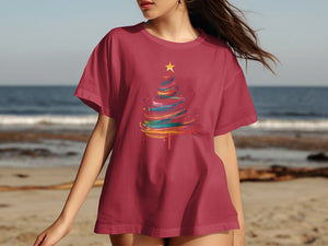 Maroon t-shirt with a colorful, abstract Christmas tree graphic and a yellow star.