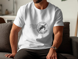 White t-shirt with a black circular stamp featuring a sea turtle and "Coastal Post Service Sea You Soon."