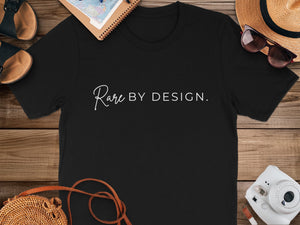 Black t-shirt with white text "Rare BY DESIGN." and accessories.