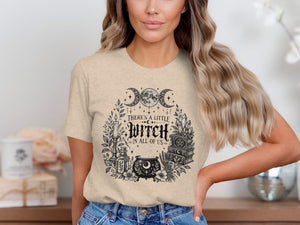 T-shirt with "There's a Little Witch In All of Us" text and witchy graphics.