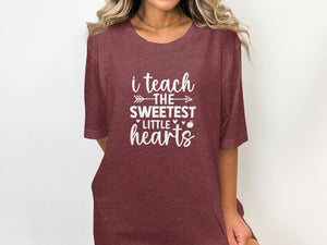 Maroon t-shirt with white text: "i teach the sweetest little hearts."