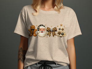 Christmas gingerbread man, Santa, bow, and tree graphic on a light t-shirt.