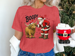 Santa boops a Highland cow on a red shirt with "BOOP!" text.