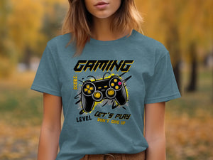 Teal t-shirt with "GAMING" text, a video game controller, and "LEVEL LET'S PLAY DON'T GIVE UP" text.