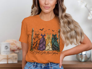 Orange t-shirt with a graphic of five dresses hanging on a line and text.
